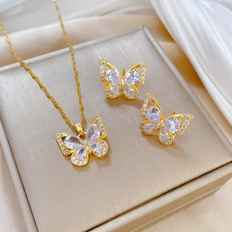 "Luxe Steel Butterfly Glow Set – Clear Gem Earrings & Pendant for Her"